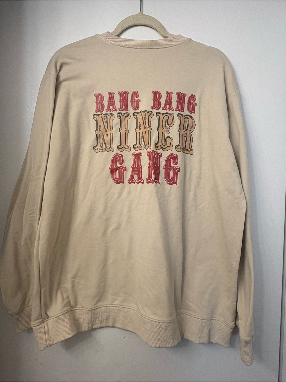 Beige Graphic Crewneck Sweatshirt with Red and Tan Lettering